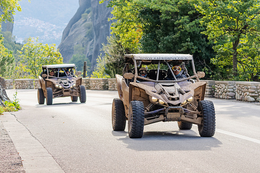 23 October 2021, Meteora, Greece: ATV buggy tours with tourists riding on asphalt road