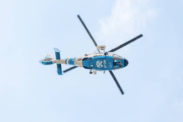 hellenic coast guard eurocopter dauphin 2 hc-31 view from the bottom against blue sky - rescue helicopter water searching imagens e fotografias de stock