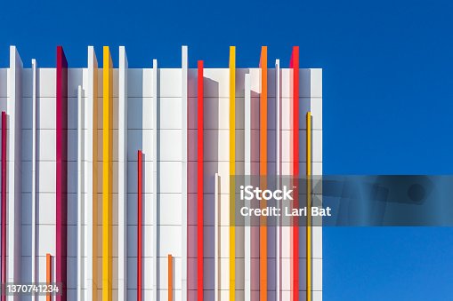istock a fragment of a white wall decorated with multicolored plastic on a blue sky background. 1370741234