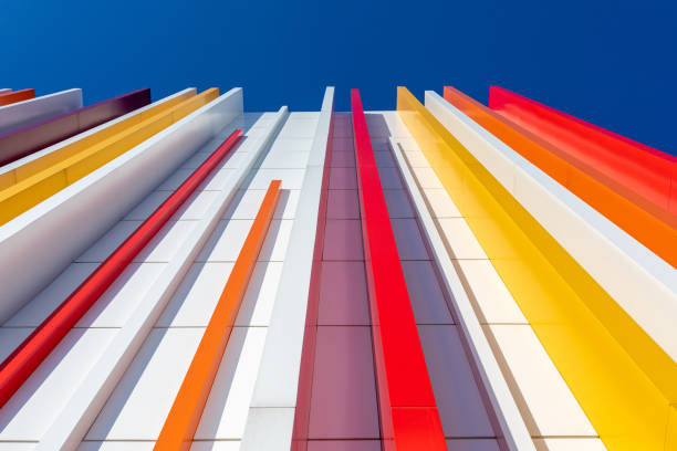 istock a fragment of a wall decorated with multicolored plastic on a blue sky background. Vertical perspective 1370741235