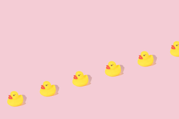 istock Creative pattern made with yellow rubber duck  on pastel pink background. Surreal bathing concept. Retro style aesthetic idea with copy space. 1370743641