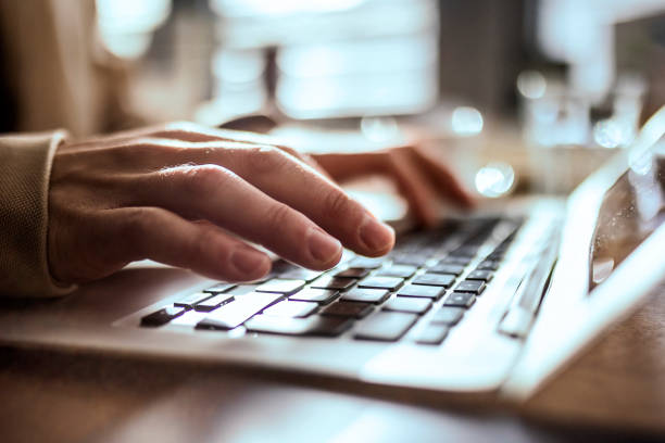istock Close up hands typing on a laptop 1370743896