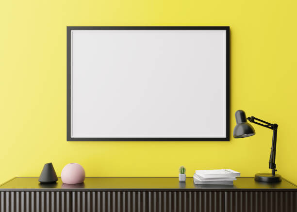 istock Empty horizontal picture frame on yellow wall in modern living room. Mock up interior in minimalist, contemporary style. Free space for your picture, poster. Console, lamp. 3D rendering. Close up view 1370746548