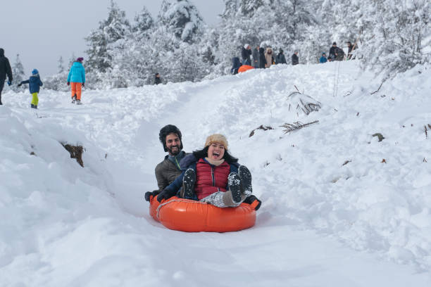 istock Sliding with tubes on snow 1370747087