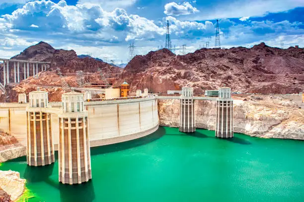 Photo of Modern Energetics Concepts. Hoover Dam and Penstock Towers in Lake Mead of the Colorado River on Border of Arizona and Nevada States.