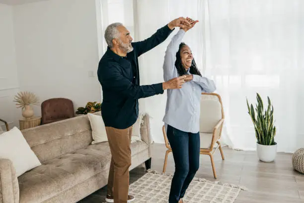Two Seniors dancing in the living room
