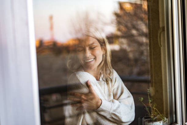istock Smiling loving young woman hugging oneself 1370754113