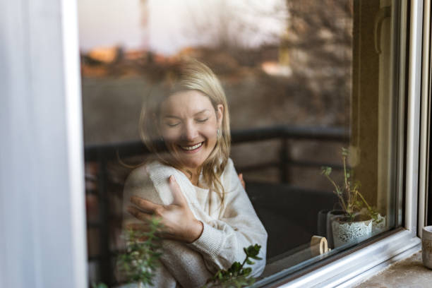 istock Smiling loving young woman hugging oneself 1370755431