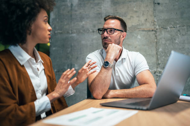 istock Two business people working together in office 1370756727