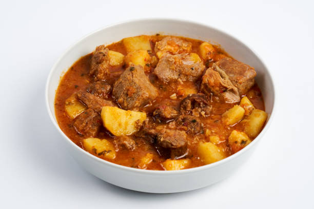 Potato stew with pork and sausages stock photo