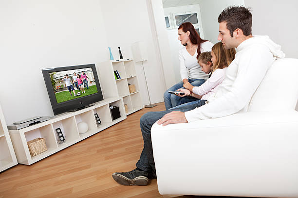 istock Young family watching TV at home 137075767