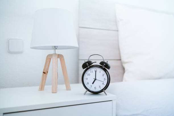 istock alarm clock at 7 am on bedroom during morning, wake up concept 1370759947
