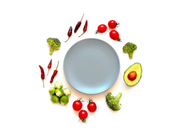 istock Ingredients for proper nutrition and empty blue plate on white background. The concept of healthy diet. 1370760069