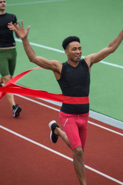 istock Handsome african athlete man crossing finish line 1370760146