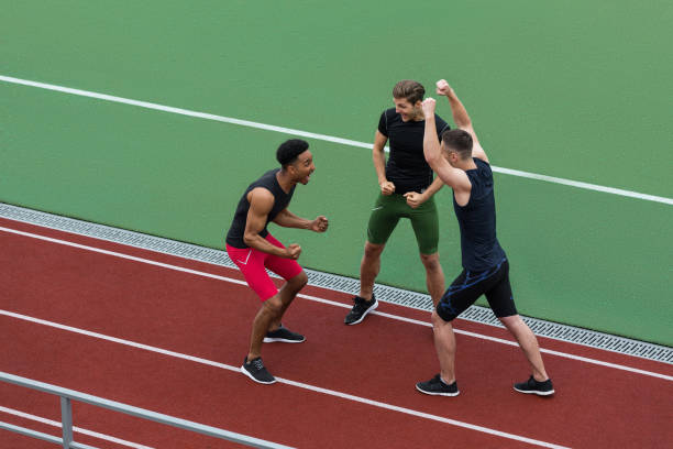 istock Happy multiethnic athlete team make winner gesture 1370760503