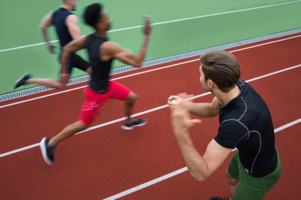 istock Handsome trainer screaming near young multiethnic athlete group 1370760716
