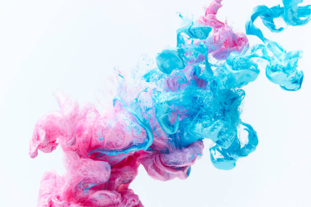 Pink and blue paint splash over gray background stock photo