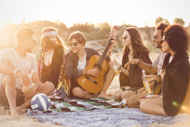 istock Mixed race friends having fun at the beach 1370762178
