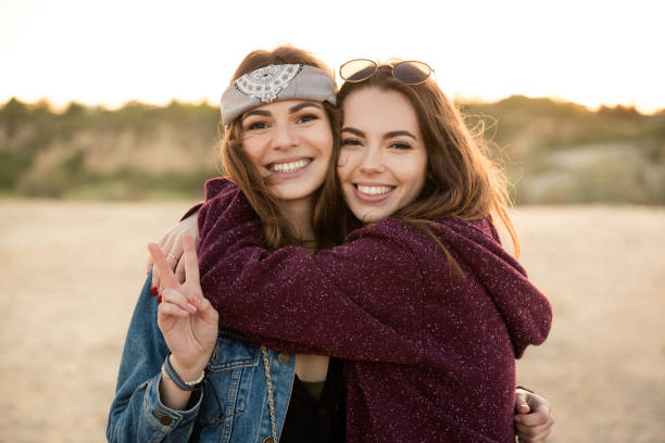 istock Two young hipster girls embracing each other 1370762791