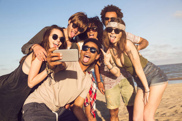 istock Cheerful multiethnic friends taking selfie at beach on sunny day 1370762901