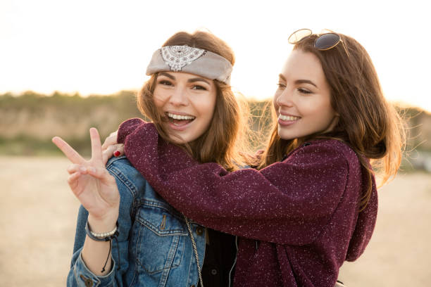 istock Two young hipster girls embracing each other 1370763081