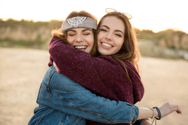 istock Two smiling feamale friends hugging each other 1370763160
