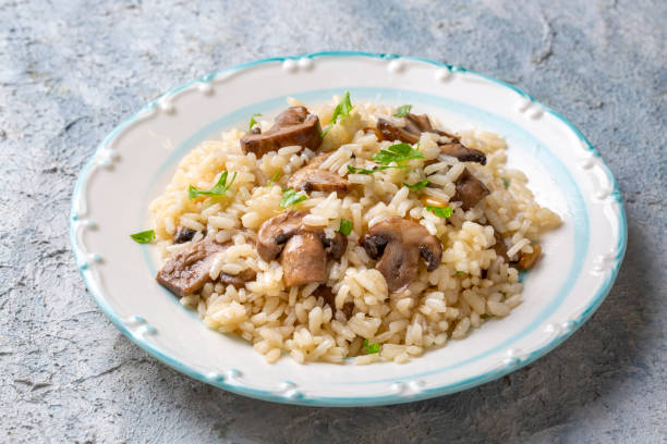 istock Mussel rice pilaf. Rice with mussels on small white plate on ceramic. 1370763233