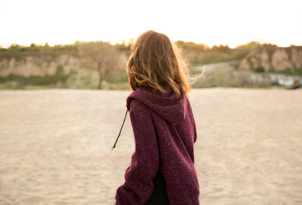 istock Back view of a young girl walking 1370763352