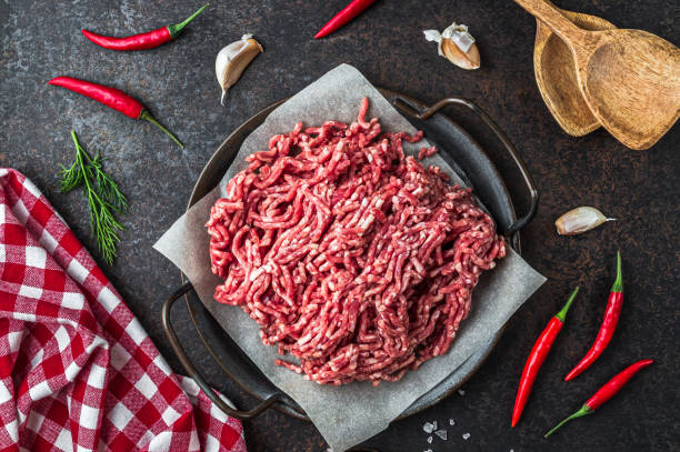 istock Raw minced beef meat on a tray over black background. 1370763446