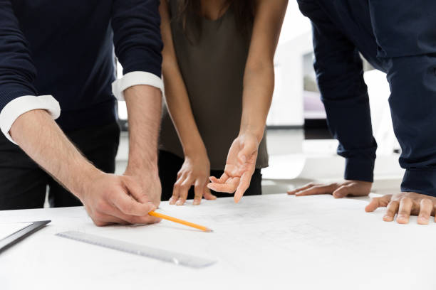 istock Group of businesspeople working at a table in the office 1370764447