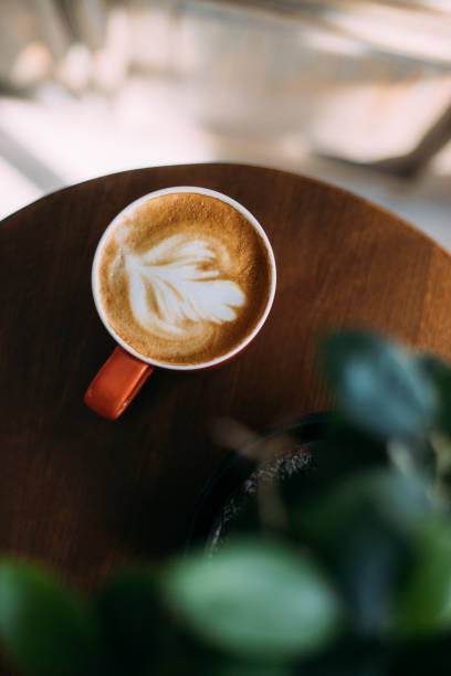 istock A latte with orange mug on wooden table 1370764514