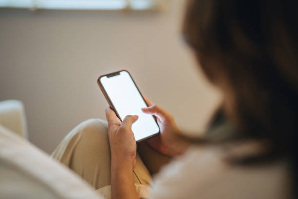 istock Young woman using mobile applications at home 1370764865