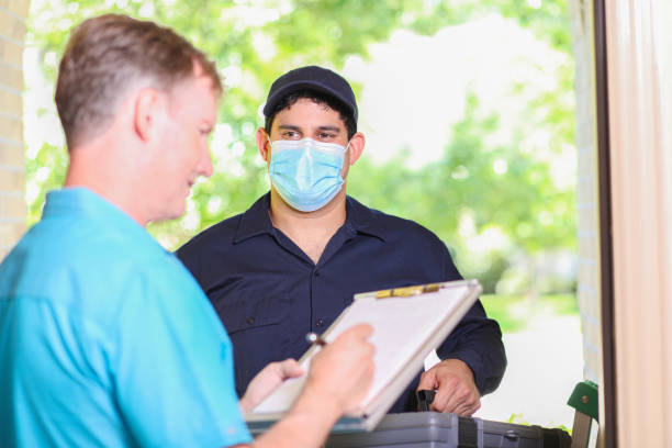 istock Latin descent repairman, technician makes house call at customer home. 1370764886