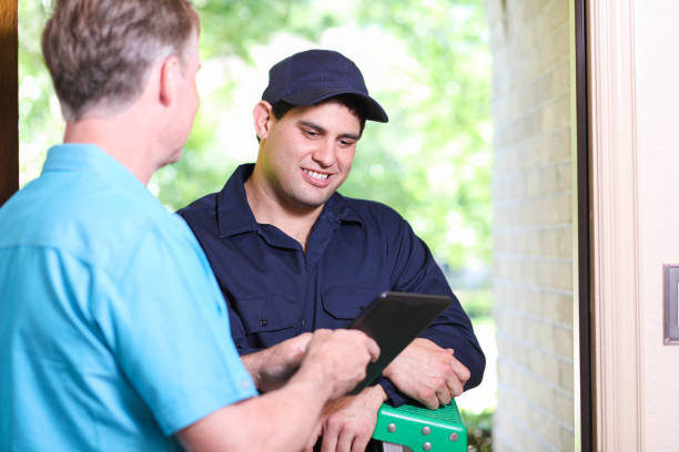 istock Latin descent repairman, technician makes house call at customer home. 1370765462
