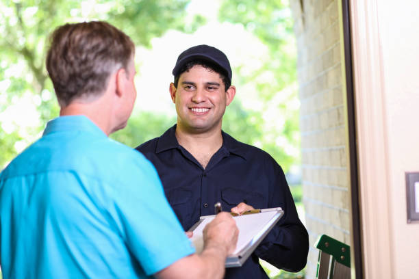 istock Latin descent repairman, technician makes house call at customer home. 1370765520