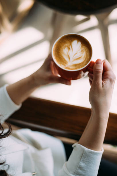 istock Woman holding a cup of latte on weekend 1370765545