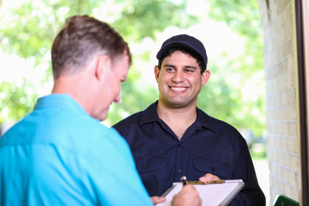 istock Latin descent repairman, technician makes house call at customer home. 1370765611