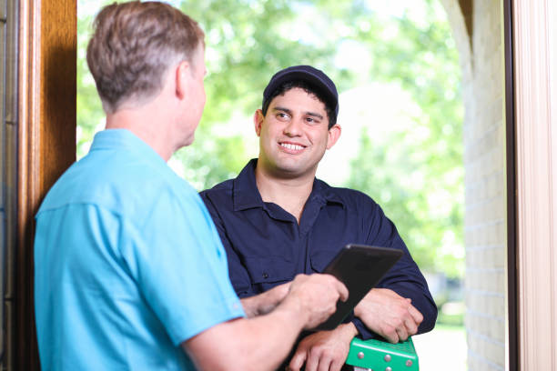 istock Latin descent repairman, technician makes house call at customer home. 1370765654