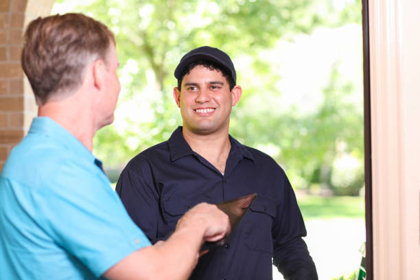 istock Latin descent repairman, technician makes house call at customer home. 1370765680