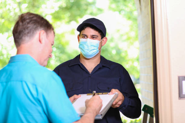 istock Latin descent repairman, technician makes house call at customer home. 1370765761