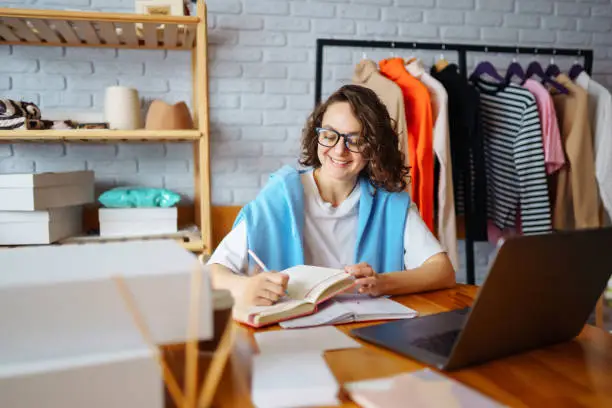 Photo of Dropshipping business owner working in her office.