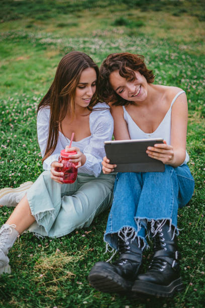 istock Two girls having fun watching a video at campus 1370768353