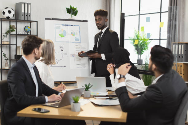 istock African man having briefing with diverse partners at office 1370768527
