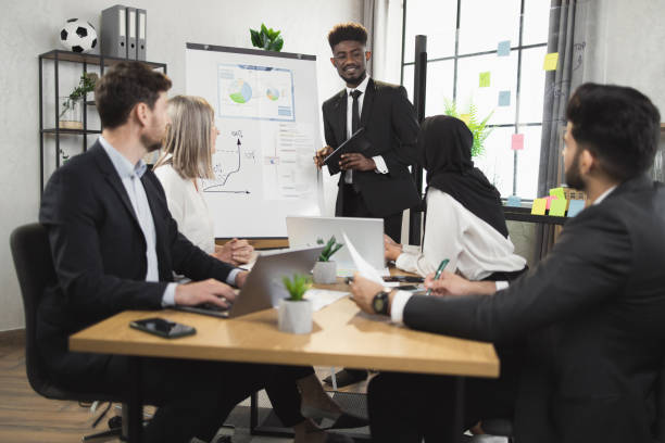istock African man having briefing with diverse partners at office 1370768545