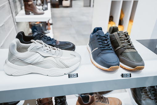 Stylish mens sneakers in the window of a fashionable shoe store