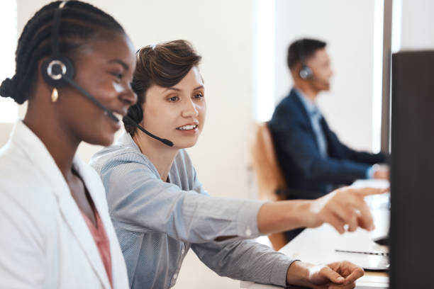 istock Shot of two call centre agents working together on a computer in an office 1370777203