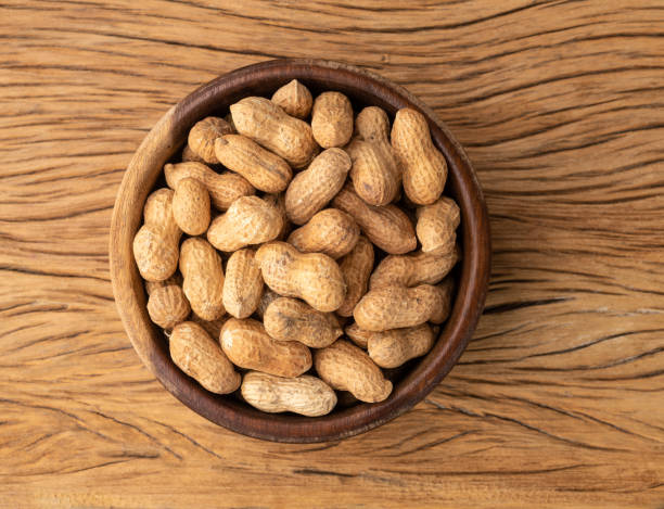 istock Shelled peanuts on a bowl over wooden table 1370777505