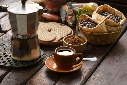 Delicious colombian espresso coffee on rustic wooden table at home fro breakfast.Image made in studio with natural window light. Image made in high resolution with a Nikon D610 24 Mp.