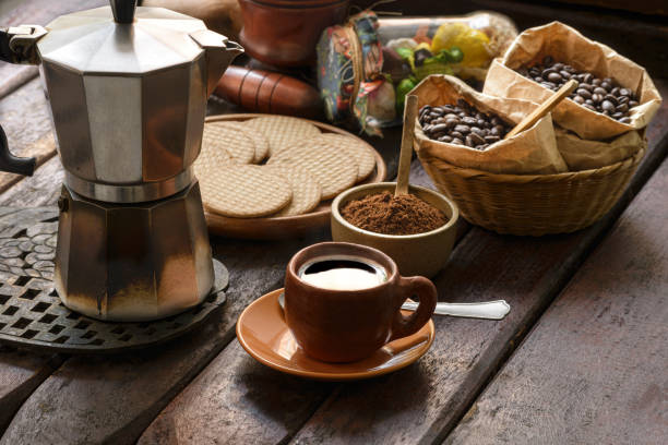 Fresh Black Coffee Espresso Delicious colombian espresso coffee on rustic wooden table at home fro breakfast.Image made in studio with natural window light. Image made in high resolution with a Nikon D610 24 Mp. Cup of Beans stock pictures, royalty-free photos & images