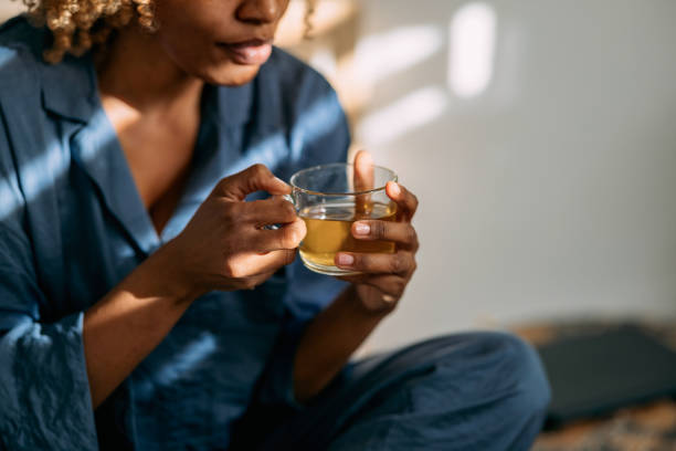 istock Anonymous Woman Enjoying a Cup of Tea in Bed 1370783677